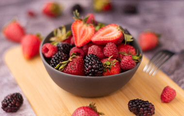 bowl full of fruit on a wooden table