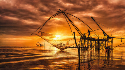 silhouette scenery of sunrise at pakpra phatthalung with thai traditional fishing trap