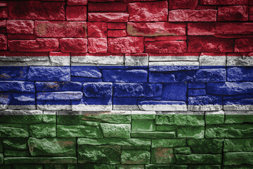 National flag of Gambia on stone  wall background.The concept of national pride and symbol of the country. Flag  banner on  stone texture background.