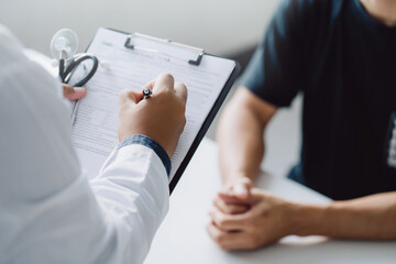 doctor holding test results and consulting patient at desk medical office,  Hospital/ clinic...