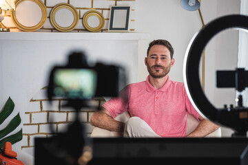 detrás de cámara de un hombre siendo entrevistado con luces y micrófonos para un blog