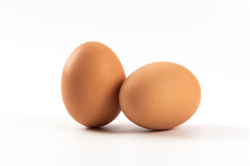 Raw brown chicken eggs on white background