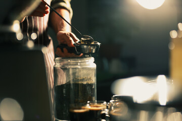 Bairsta use spoon to fetch ground coffee prepare for making cup of coffee.