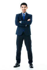 Portrait of smiling young Asian businessman in crossed arms pose on isolated white background. Studio shot, business and success concept.
