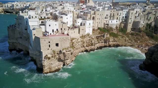 Belvedere Terrazza Santo Stefano With People Swimming  On The Beach At Polignano a Mare, Italy. - aerial
