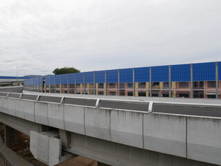SELANGOR, MALAYSIA - JULY 5, 2020: Noise barriers are installed along the vehicle lane bordering the residence to prevent noise pollution to the surrounding locals.
