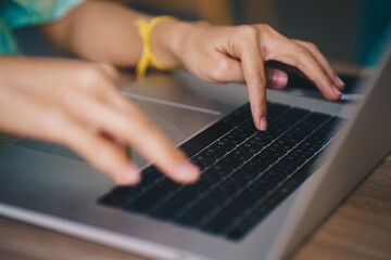 Fototapeta na wymiar Women hand typing on laptop sitting in office
