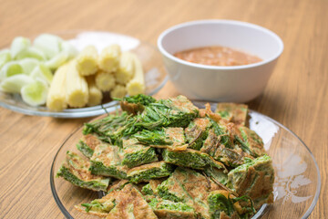 Thai food, Acacia Pennata Omelette and Shrimp-paste sauce, vegetables on wooden table background.