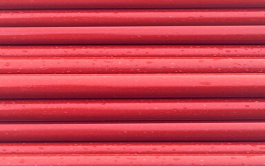 Red steel pipes for fire fighting system and extinguishing water lines in industrial building. Paint shop. Steel pipe painted red color. painted steel pipes. 