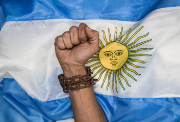 Fists that break the chains on the Argentine flag. Argentine revolution and independence concept