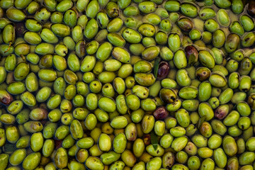Closeup of submerged olives in production process