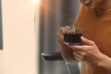 Cropped shot of charming man holing cup of hot tea or coffee.