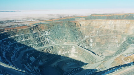 Deep open-pit mine filmed during daylight