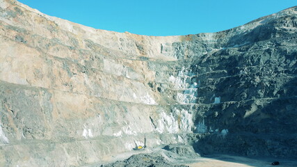 Deep open-pit mine with a drilling machine working in it