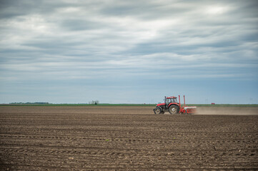 Sowing crops at agricultural fields in spring