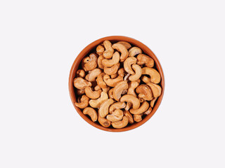Ceramic bowl with cashew nuts isolated on white