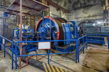 Fototapeta na wymiar Huge shaft elevator machine. Modern equipment for lifting and lowering the cage shaft