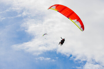 paragliders soar high in the sky