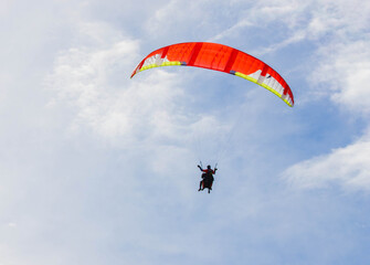 paraglider soars high in the sky