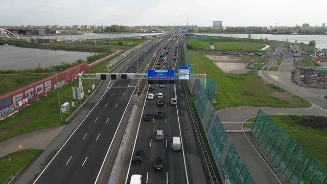 Dutch highway near Amsterdam Zeeburg A10 exit S114 and a small traffic jam aerial view.