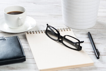 Top view office desk with white cup of coffee