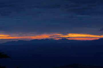 dark spooky gloomy clouds and large mountain sky at sunset background wallpaper
