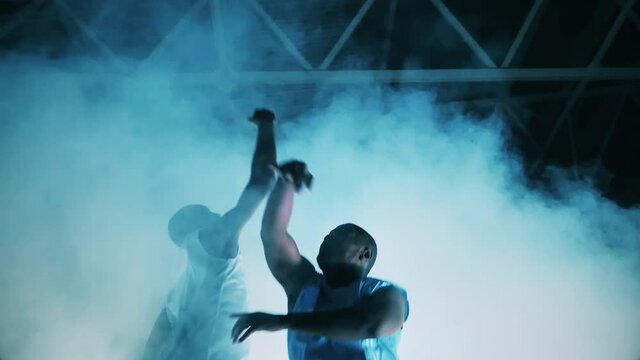 African-american athletes are jumping to gather a basketball