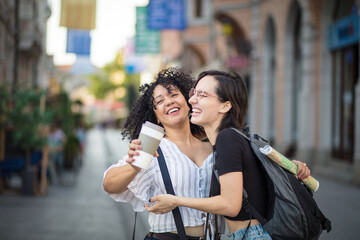 Fototapeta premium Friendship. Two tourist women on street.