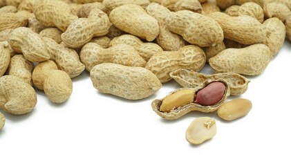 Heap of dried peanuts with peeled, Monkey nuts, Groundnuts, Isolated on white background, Close up