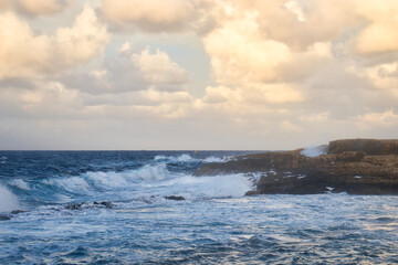 Colorful clouds at sunset over the ocean in Qawra, Malta.