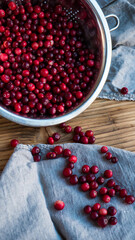 Cranberry autumn harvest. Healthy lifestyle berries on wetlands. Linen napkin on a wooden rustic table.