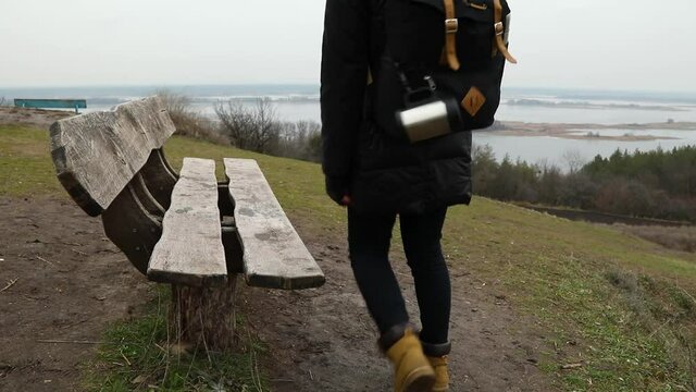 slow motion Woman backpacker traveler coming and sitting on bench, relaxing, break Digital wellbeing, limiting screen time, mindful living