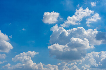 Naklejka na ściany i meble Cumulus clouds against summer sky background and daylight