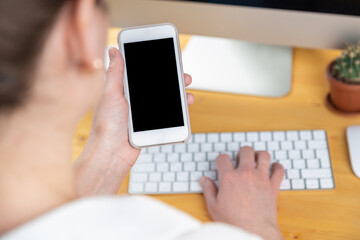 hands of women who use laptop keyboard and mobile phone. concept of email delivery and use of online technology