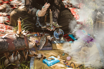 Gypsy soul... Boho woman with Tarot cards, candles and magic ball at field, lifestyle, predicting,...