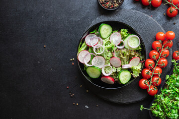 vegetable salad radish, cucumber, mix leaves meal snack summer menu diet vegan or vegetarian food copy space food background rustic top view