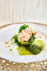 Crab salad tartare. Fresh Crab, avocado and pesto sauce with red caviar on a plate. Selective focus