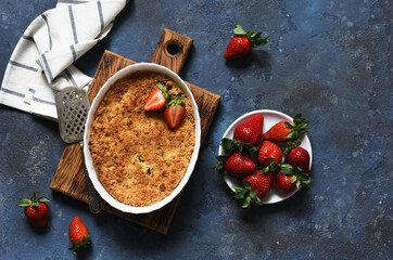 Crumble with strawberries on a benton background. View from above.