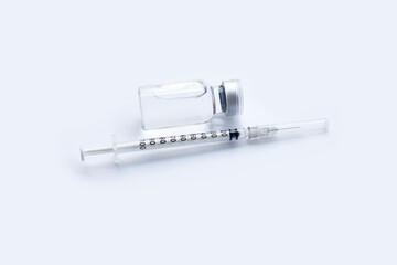Bottle of vaccine and syringe on white background with copy space. Covid-19 Coronavirus concept