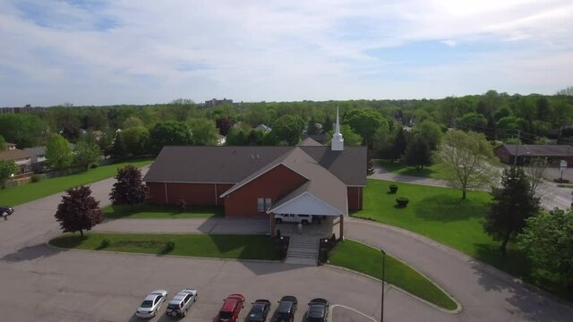 Aerial shot of people arriving to church building