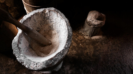 Ancient flour mortar. Wooden vessel for manual hand grinding. Authentic craft workshop. This method...