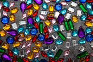 colored rhinestones on a gray background close-up