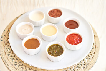 Sauces ketchup, mustard, mayonnaise, sour cream, soy sauce in clay bowls on table.