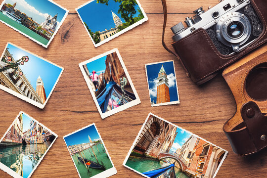 Vintage retro camera with travel photos on wooden background