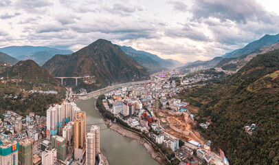 aerial of the city near the river and mountains 