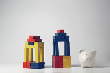 Pig piggy bank with wooden blocks arranged in a bar graph concept savings commensurate with the investment.