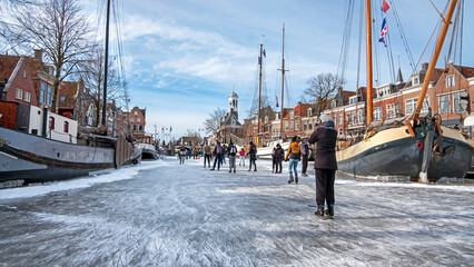 Winter fun in the city Dokkum on the canals in the Netherlands