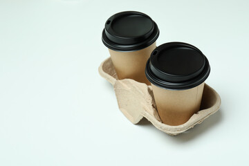 Cup holder with paper cups on white background