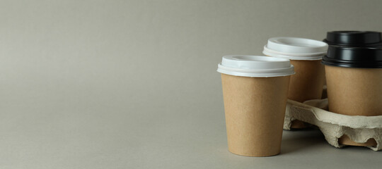Cup holder with paper cups on light gray background