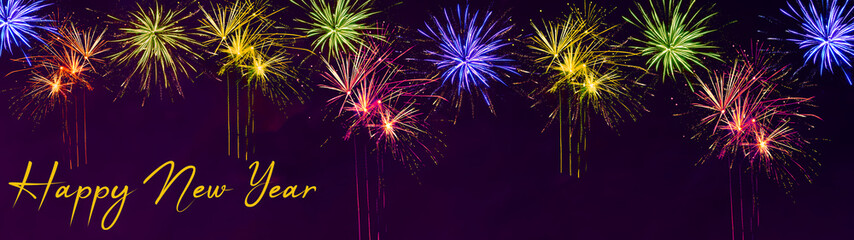 Silvester New Year background banner panorama long- Colorful firework on dark purple night sky